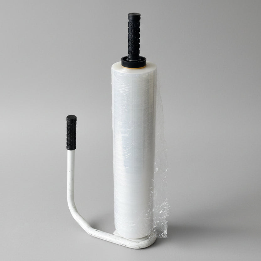 A hand dispenser for stretch-wrap featuring an ergonomic grip. A hand dispenser for stretch-wrap featuring an ergonomic grip.