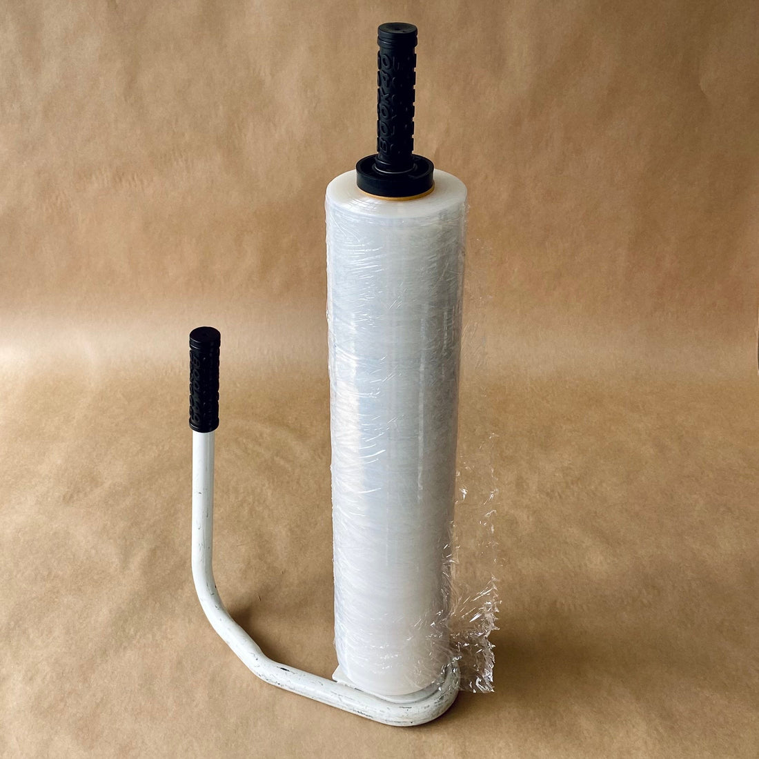 Hand stretch-wrap roll on a metal dispenser