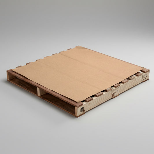 Wooden pallet with a cardboard cover on a gray concrete floor