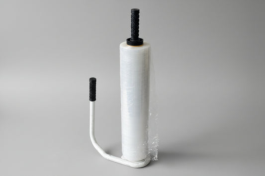 A hand dispenser for stretch-wrap with a roll of plastic film wrapped around a spool, featuring an ergonomic grip.
